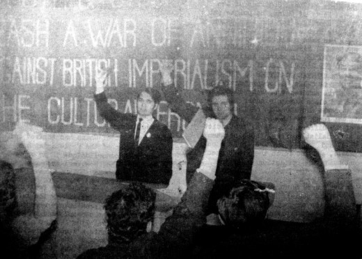 Clenched fist salute in front of banner